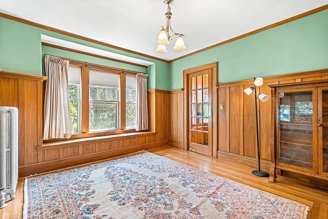 68 Barnard Ave, Watertown, MA 02472 - dining space featuring healthy amount of natural light, wood finished floors, radiator, crown molding, and wainscoting