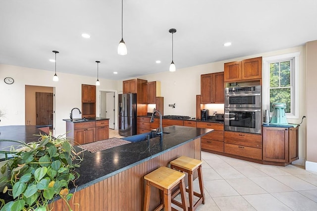 19 Hardscrabble Rd, Sterling, MA 01564 - kitchen with refrigerator with ice dispenser, stainless steel double oven, brown cabinetry, dark countertops, and a breakfast bar area