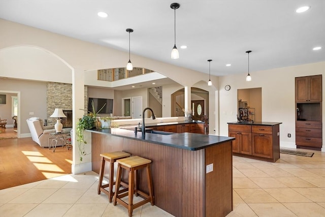 19 Hardscrabble Rd, Sterling, MA 01564 - kitchen featuring arched walkways, dark countertops, recessed lighting, light tile patterned flooring, and a breakfast bar area