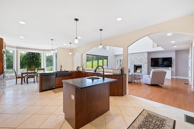 19 Hardscrabble Rd, Sterling, MA 01564 - kitchen featuring dishwasher, a large island, dark countertops, light tile patterned floors, and a fireplace