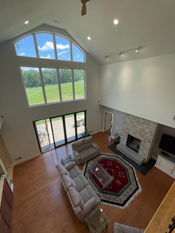 19 Hardscrabble Rd, Sterling, MA 01564 - living room with high vaulted ceiling, a fireplace, light wood finished floors, recessed lighting, and rail lighting