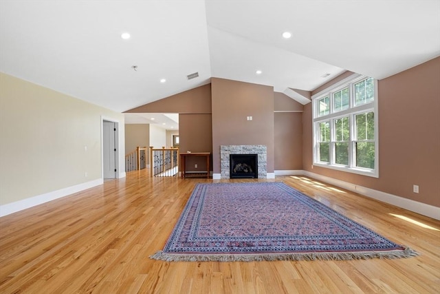 19 Hardscrabble Rd, Sterling, MA 01564 - unfurnished living room with light wood-style flooring, a stone fireplace, and high vaulted ceiling