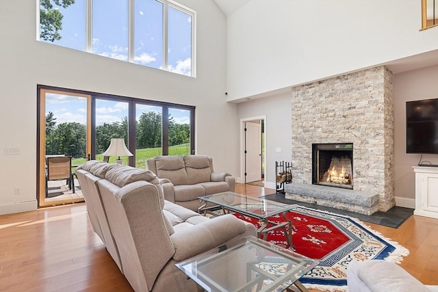 19 Hardscrabble Rd, Sterling, MA 01564 - living area with wood finished floors, healthy amount of natural light, a high ceiling, and a fireplace