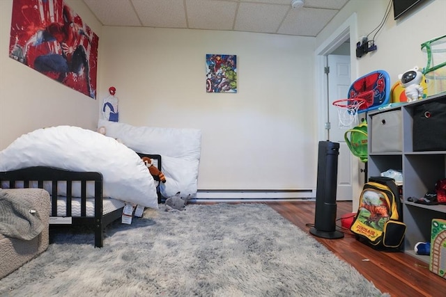 79-81 N Main St, Webster, MA 01570 - bedroom with a paneled ceiling, wood finished floors, and a baseboard heating unit