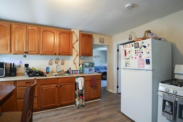79-81 N Main St, Webster, MA 01570 - kitchen with white appliances, dark wood-style flooring, light countertops, and brown cabinetry