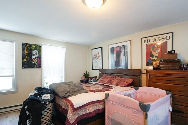 79-81 N Main St, Webster, MA 01570 - bedroom with a baseboard heating unit and wood finished floors