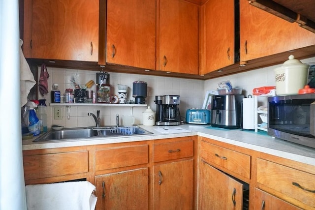 79-81 N Main St, Webster, MA 01570 - kitchen with tasteful backsplash, stainless steel microwave, light countertops, and brown cabinetry