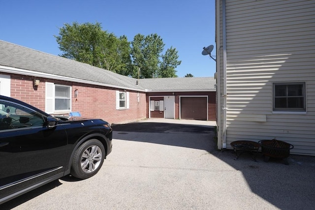 79-81 N Main St, Webster, MA 01570 - view of side of home with an attached garage, driveway, and brick siding