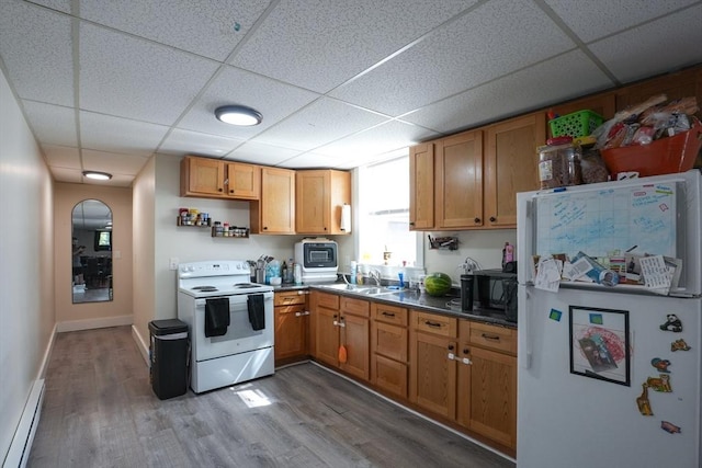 79-81 N Main St, Webster, MA 01570 - kitchen with white appliances, a drop ceiling, baseboard heating, wood finished floors, and open shelves