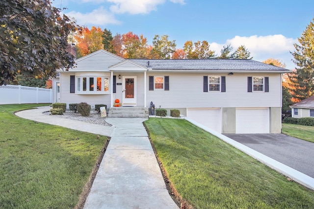 view of front of home featuring a front yard and a garage