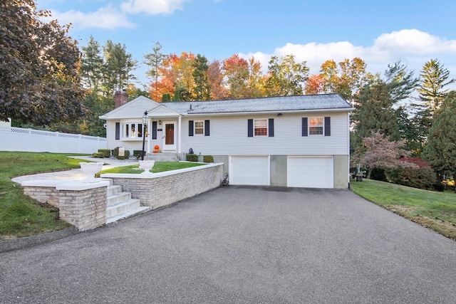 view of front of house with a front yard and a garage