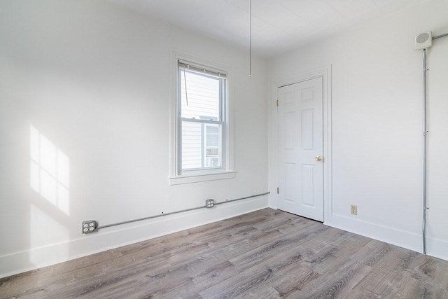 empty room featuring baseboards and wood finished floors