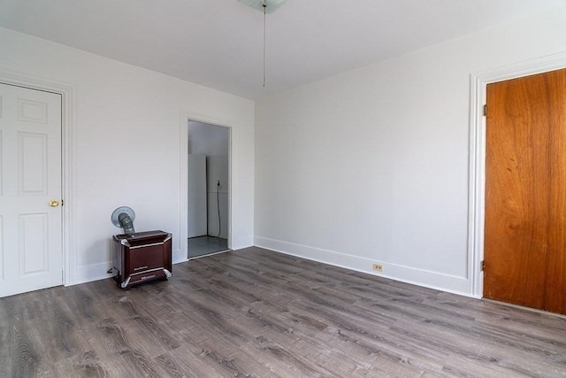 empty room with wood finished floors and baseboards