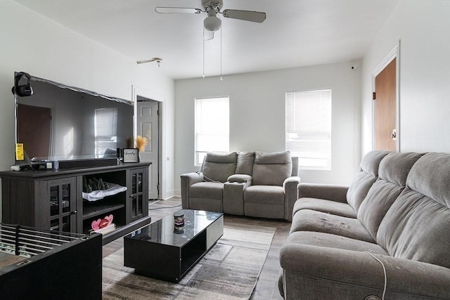 living room with a ceiling fan and wood finished floors