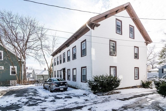 view of snow covered exterior with cooling unit