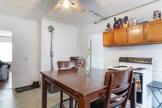 dining space with ceiling fan, light floors, and a textured ceiling