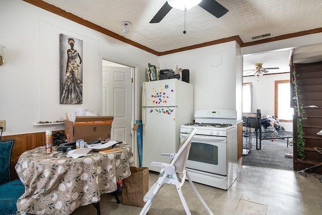 kitchen with visible vents, a textured ceiling, white appliances, crown molding, and ceiling fan