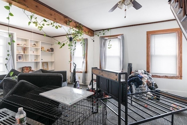 living area with baseboards, beam ceiling, and ceiling fan