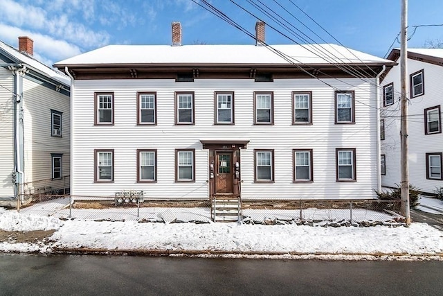 view of front of house with a fenced front yard and a chimney