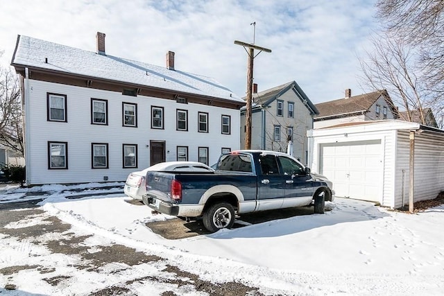 view of front of home with an outdoor structure and a chimney