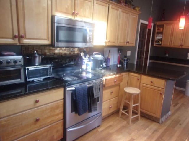 14 Mutton Ln, Weymouth, MA 02189 - kitchen with stainless steel appliances, light wood finished floors, tasteful backsplash, a peninsula, and open shelves
