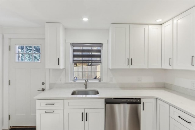 kitchen with white cabinetry, sink, and stainless steel dishwasher