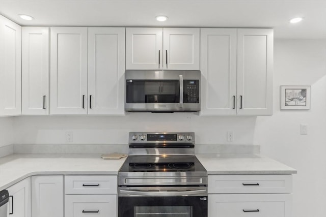 kitchen with white cabinetry and stainless steel appliances