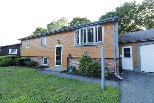 exterior space with a garage and a yard