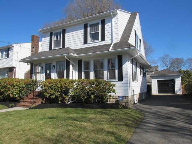 view of front facade with an outdoor structure, a front lawn, and a detached garage