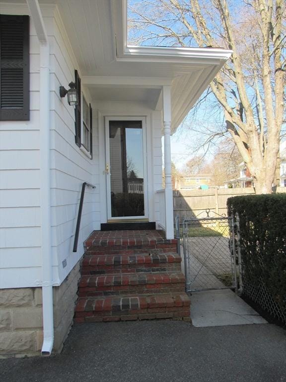 doorway to property with fence and a gate
