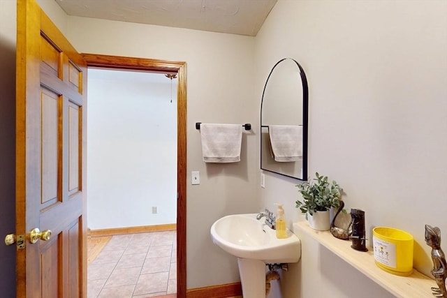 bathroom with baseboards and tile patterned floors