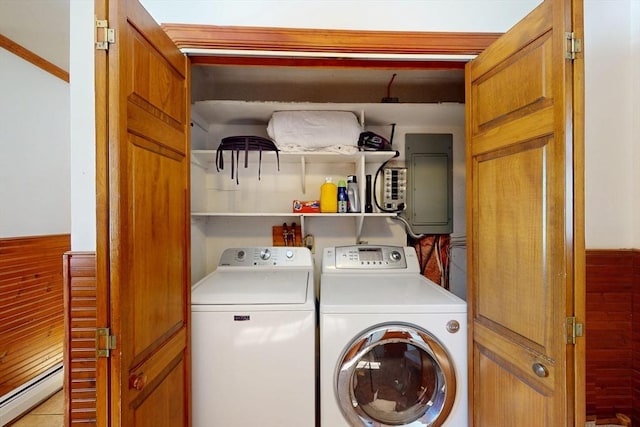 washroom with laundry area, baseboard heating, washing machine and dryer, and electric panel