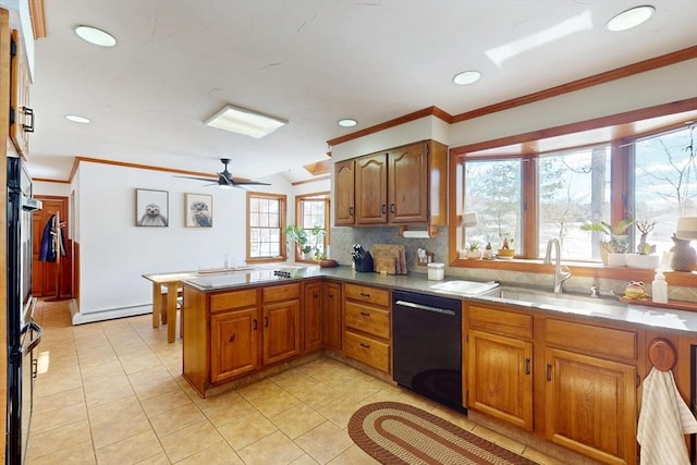 kitchen featuring a baseboard radiator, brown cabinetry, a sink, a peninsula, and black appliances