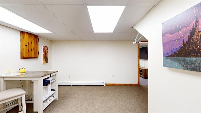 interior space featuring a baseboard radiator, carpet flooring, a paneled ceiling, and baseboards