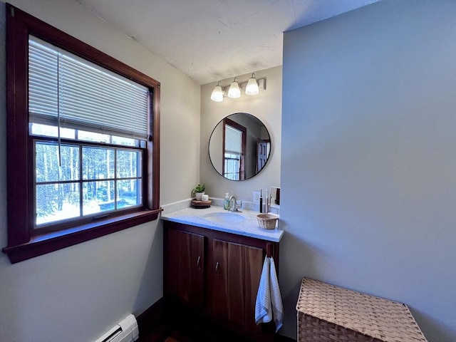 bathroom featuring vanity and baseboard heating