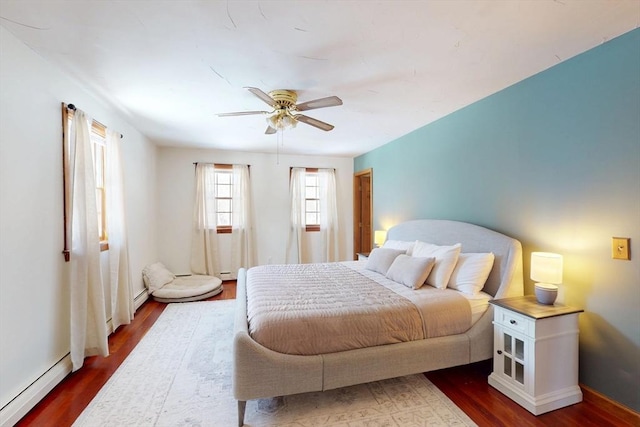 bedroom featuring a baseboard radiator, ceiling fan, and wood finished floors