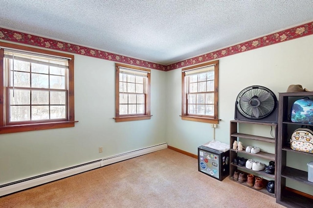 miscellaneous room featuring carpet floors, a baseboard radiator, a textured ceiling, and baseboards