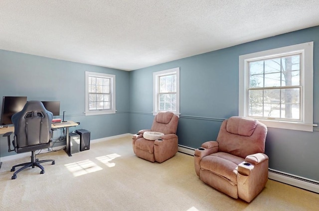 carpeted office with a textured ceiling, baseboard heating, and baseboards