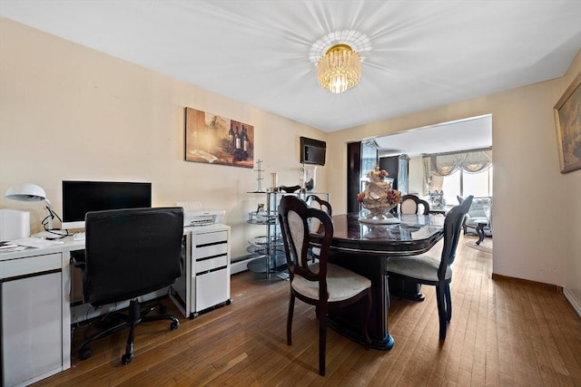 dining space with a wall mounted air conditioner and dark hardwood / wood-style floors