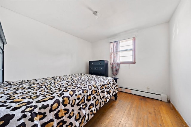 bedroom featuring hardwood / wood-style floors and baseboard heating