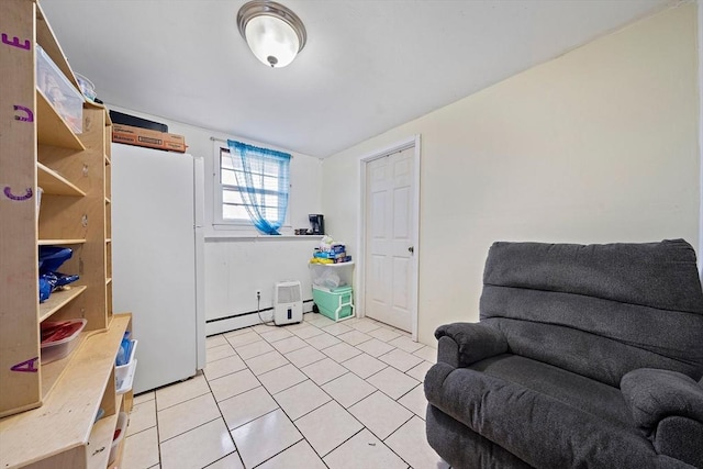 sitting room with light tile patterned floors and baseboard heating