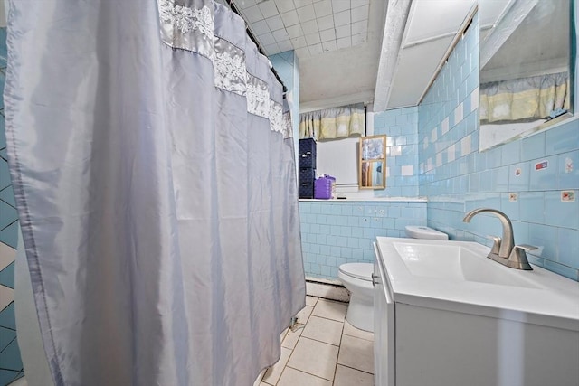 bathroom featuring baseboard heating, tile walls, vanity, tile patterned floors, and toilet