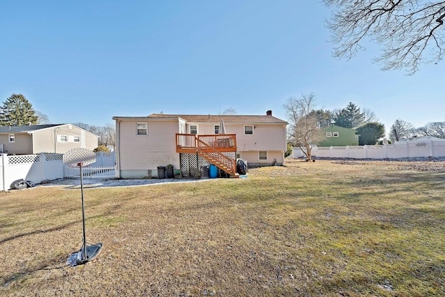 rear view of house featuring a deck and a lawn