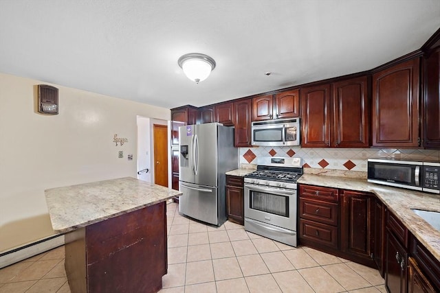 kitchen with light tile patterned floors, decorative backsplash, a baseboard radiator, and appliances with stainless steel finishes