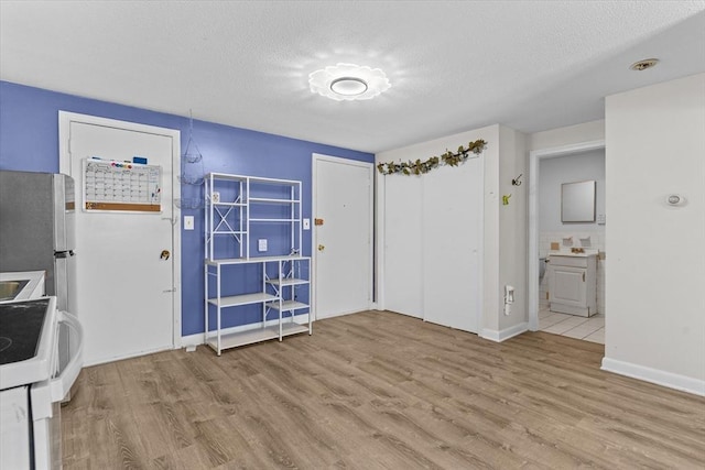 interior space featuring light hardwood / wood-style flooring and a textured ceiling