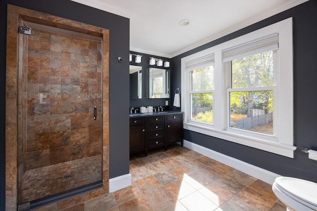 full bathroom with ornamental molding, a stall shower, vanity, and baseboards