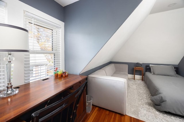 interior space featuring lofted ceiling and wood finished floors