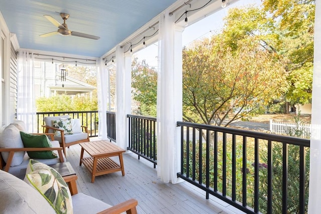 balcony with a porch and a ceiling fan