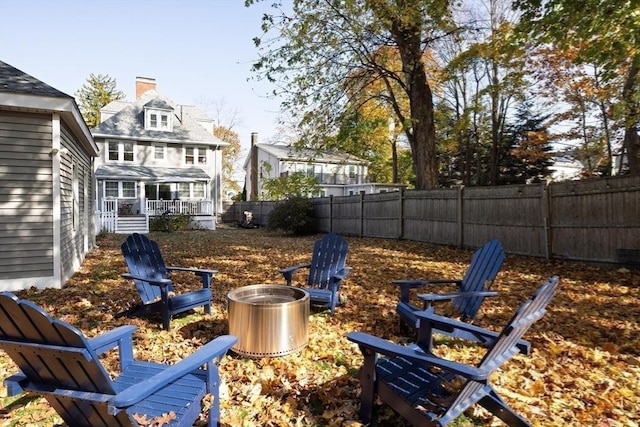 view of yard featuring an outdoor fire pit and a fenced backyard