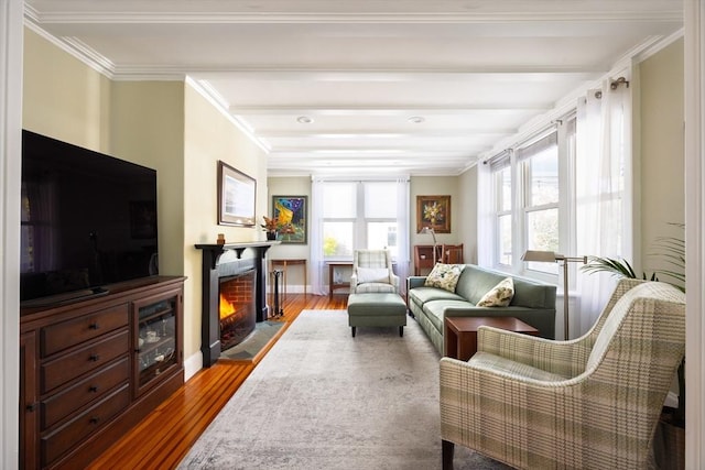 sunroom featuring a warm lit fireplace and beam ceiling